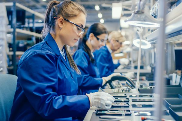 assembly line employees working on kits