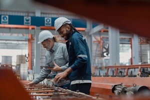engineers and staff are inspecting systems and components in a metal sheet and metal roofing manufacturing plant