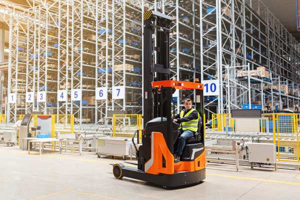 forklift operators driving around a warehouse