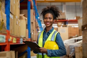 portrait of female staff smiling with holding clipboard standing in warehouse with looking at camera, Industrial and industrial workers concept