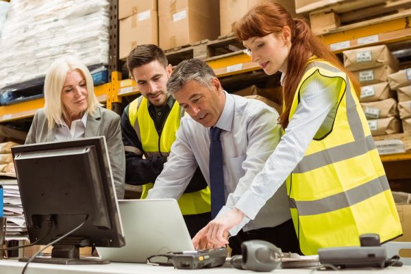 warehouse manager looking over employee headcount