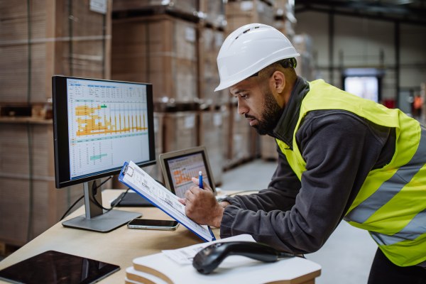 warehouse manager reviewing payroll for the month