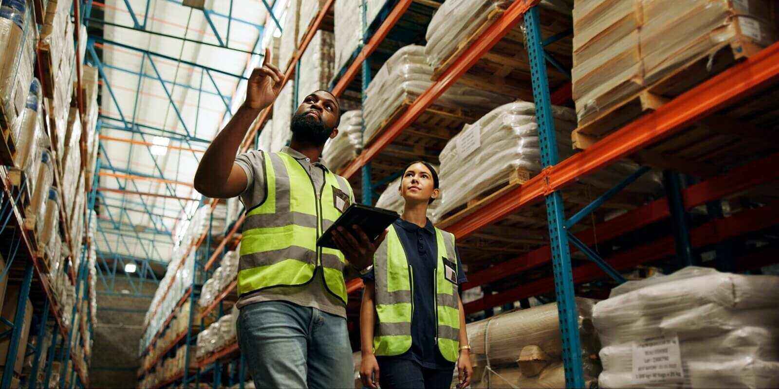 woman, man and logistics in warehouse with tablet for quality control, stock management or delivery