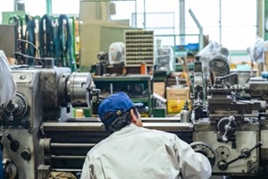 workers operating a machine in a factory