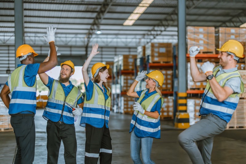 warehouse team members celebrating after a great performance review