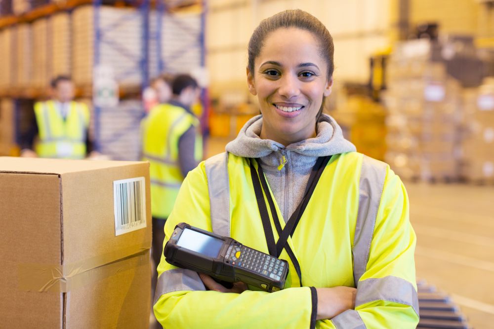 warehouse worker at their workstation packing excess inventory and applying labels